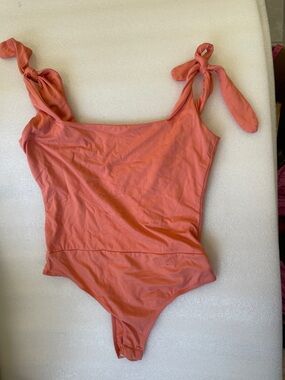 Pink Lily Women’s Coral-Peach Tie-Strap One-Piece body suit. Size m